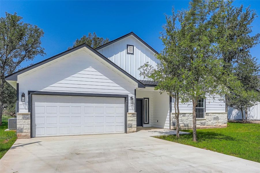 View of front of property driveway, and a garage
