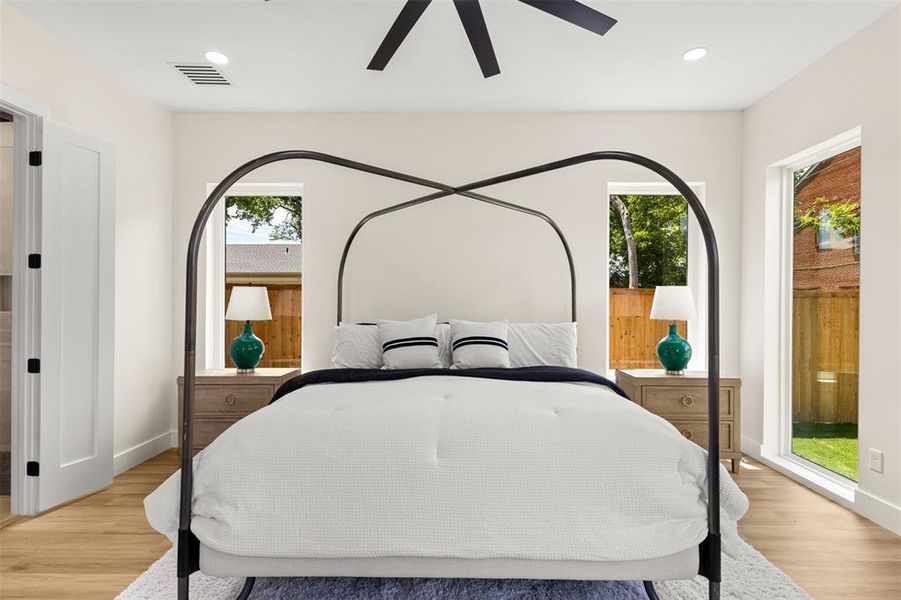 Spacious room featuring wood-finish flooring, recessed lighting, and a contemporary ceiling fan