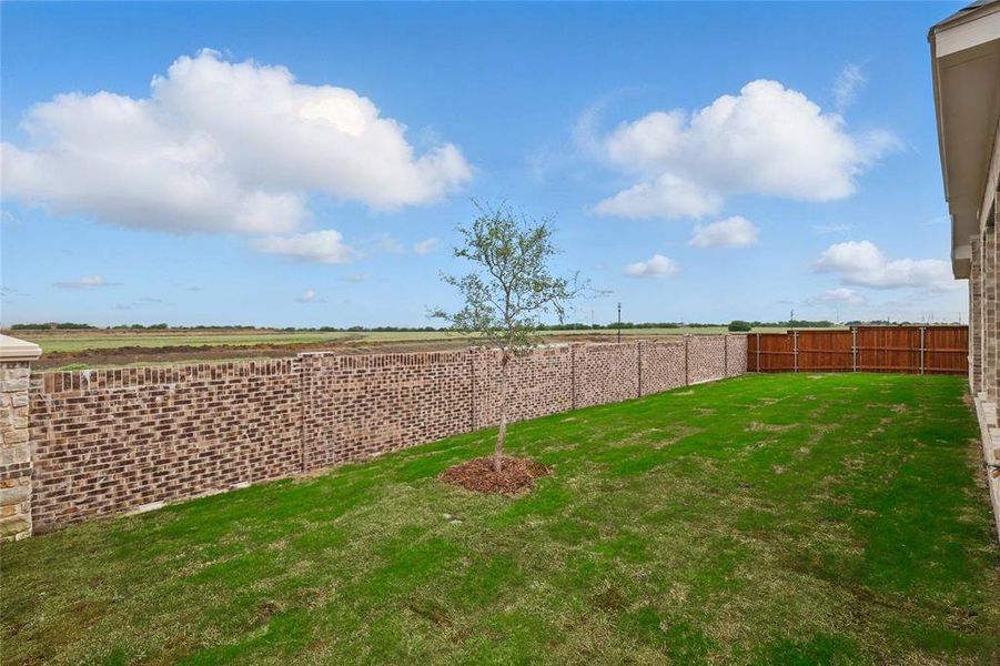 View of yard featuring fence
