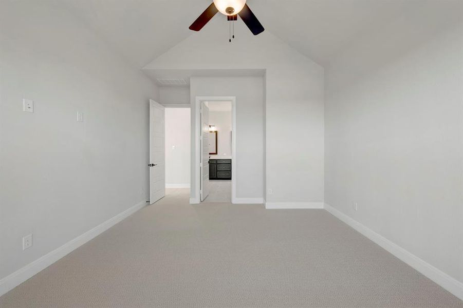 Unfurnished room featuring light carpet and a ceiling fan Unfurnished room featuring light carpet and a ceiling fan