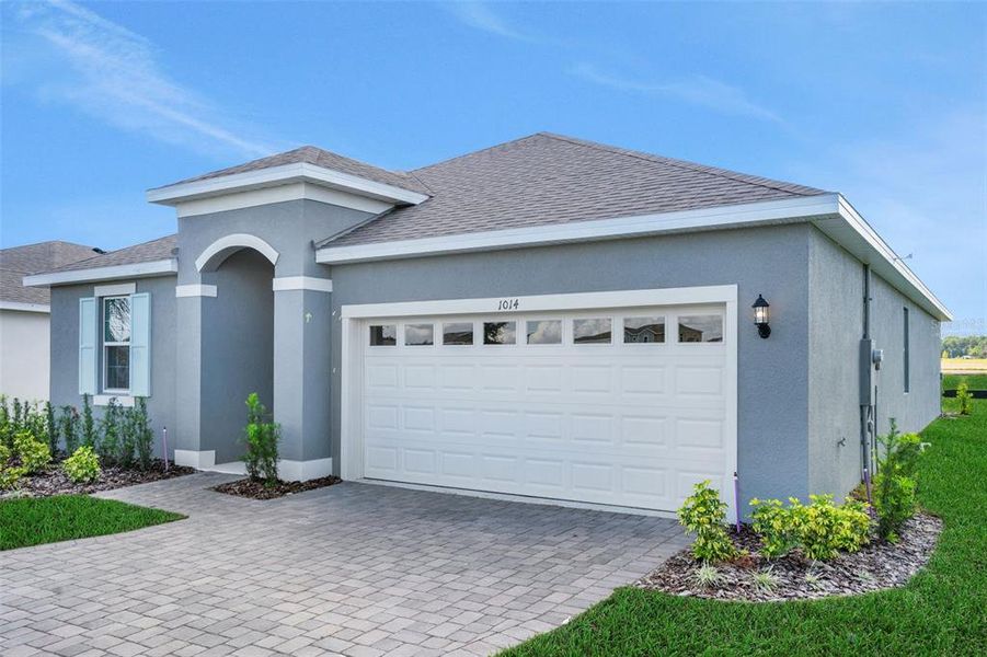 Front exterior of a new home in Reserve at Hammock Oaks, Lady Lake, FL, highlighting curb appeal (Image 1).