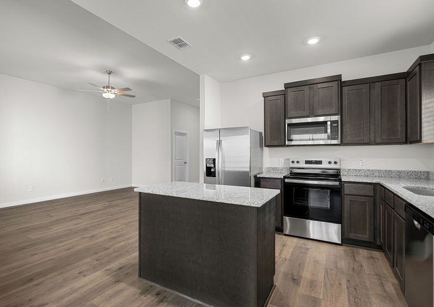 The kitchen has beautiful wood cabinetry.