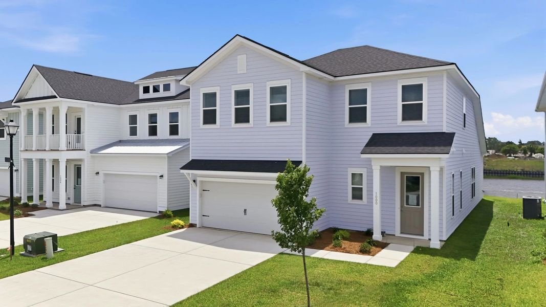 Front exterior of a new home in Blue Heron Retreat, Little River, SC, highlighting curb appeal (Image 2). Front exterior of a new home in Blue Heron Retreat, Little River, SC, highlighting curb appeal (Image 2).