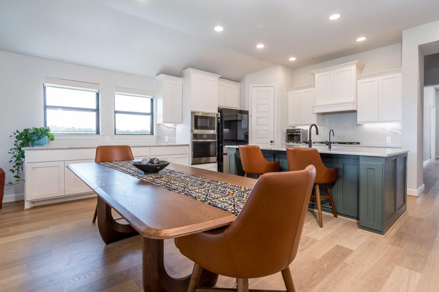 Inviting and functional dining room area has easy access to the kitchen, but still feels like you are part of the family room activities... especially on game day! The two large windows provide an unrivaled water view to enjoy. Inviting and functional dining room area has easy access to the kitchen, but still feels like you are part of the family room activities... especially on game day! The two large windows provide an unrivaled water view to enjoy.