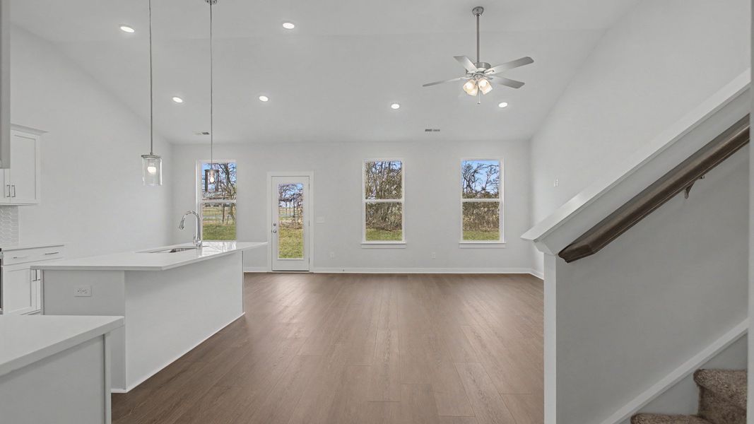 Soaring vaulted ceilings over the kitchen, dining, and gathering areas