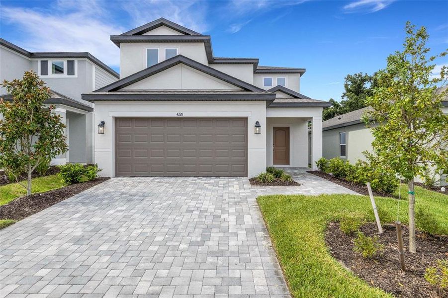 Front exterior of a new home in Southpointe, Palmetto, FL, highlighting curb appeal (Image 24).