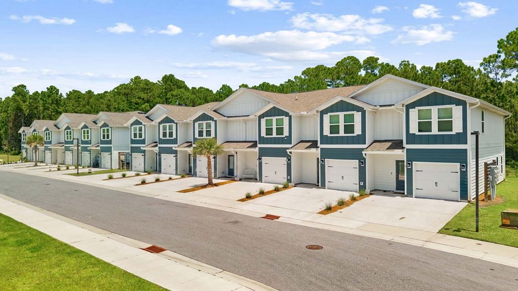 Front exterior of a new home in Hawks Landing Townhomes, Santa Rosa Beach, FL, highlighting curb appeal (Image 1). Front exterior of a new home in Hawks Landing Townhomes, Santa Rosa Beach, FL, highlighting curb appeal (Image 1).