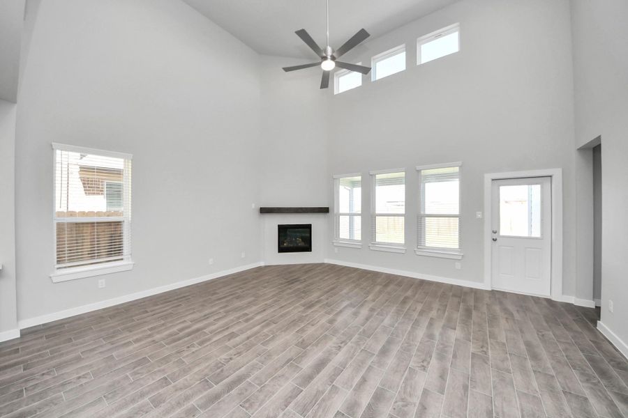 Welcome family and guests to your charming living room! With its high ceilings, recessed lighting, ceiling fan, custom paint, beautiful flooring, and large windows that let in abundant natural light, this room is perfect for gatherings. Welcome family and guests to your charming living room! With its high ceilings, recessed lighting, ceiling fan, custom paint, beautiful flooring, and large windows that let in abundant natural light, this room is perfect for gatherings.