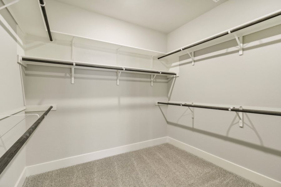 Primary suite walk-in closet in the Cedar floorplan at a Meritage Homes community.