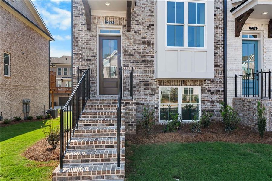 Exterior details and patio area of a home in Evanshire Townhomes, Duluth (Image 3).