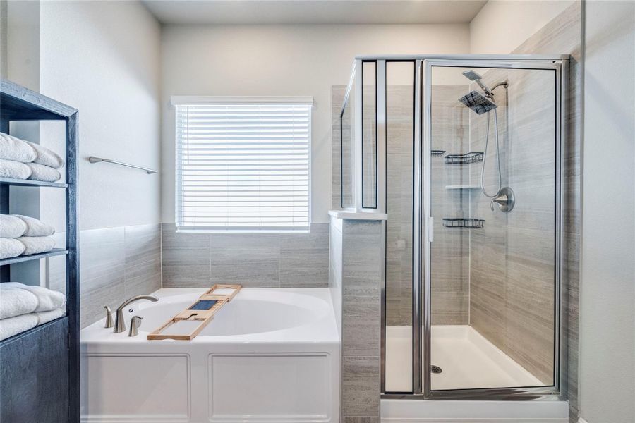 Spa-like primary bathroom with upgraded cabinets.