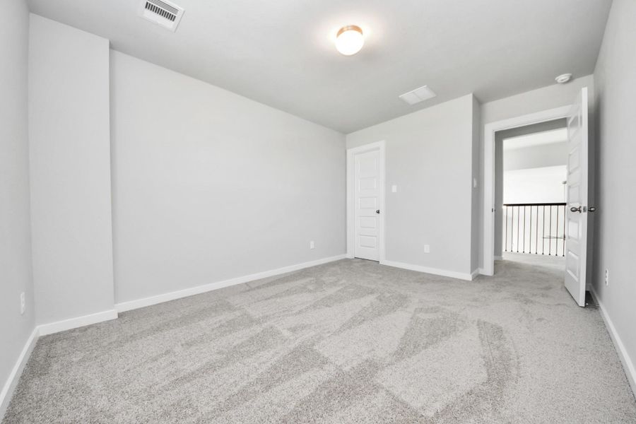 Generously sized secondary bedrooms featuring spacious closets, soft and inviting carpeting underfoot, large windows allowing plenty of natural light, and the added touch of privacy blinds for your personal retreat. Sample photo of completed home with similar floor plan. Actual colors and selections may vary.