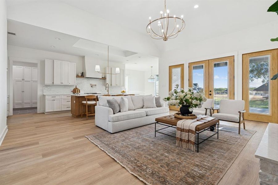 Champagne fixtures are timeless and elegant. Behind the photographer is a hall of bedrooms; primary is beyond the kitchen.