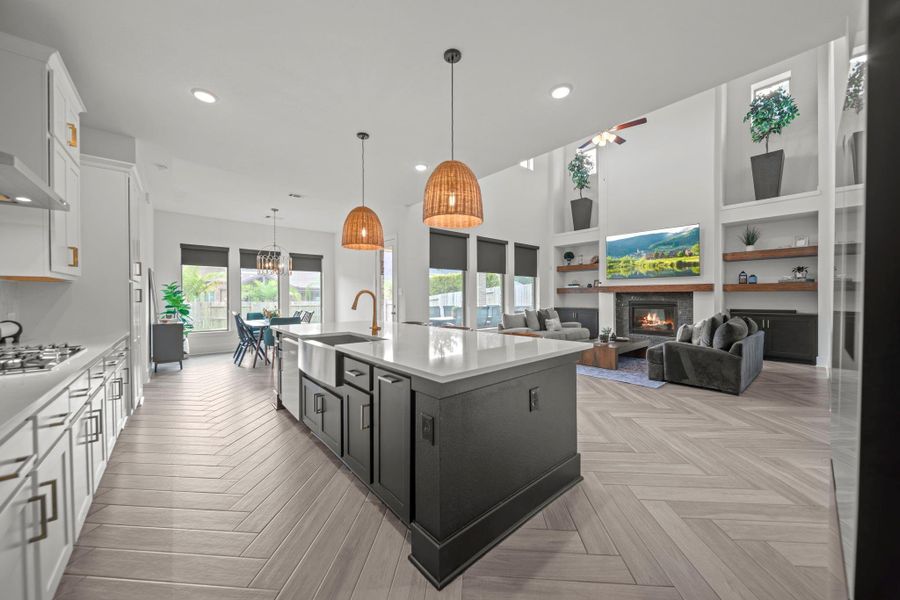 Beautifully open kitchen with oversized island, pendant lighting, and a view into the living and dining spaces. Designed for seamless connection while entertaining. Beautifully open kitchen with oversized island, pendant lighting, and a view into the living and dining spaces. Designed for seamless connection while entertaining.