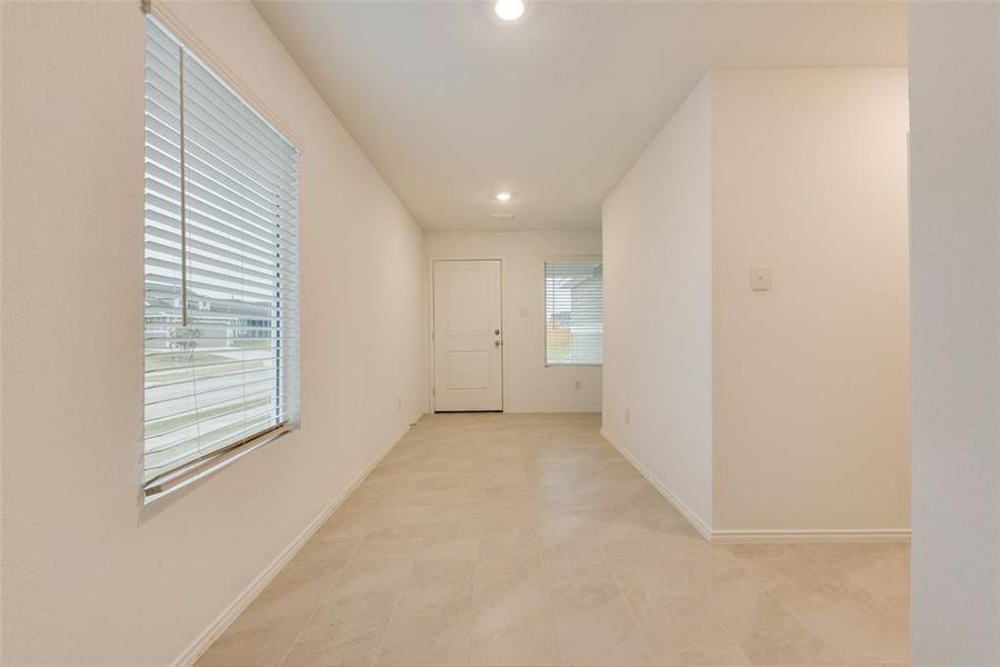 Corridor with light tile patterned floors