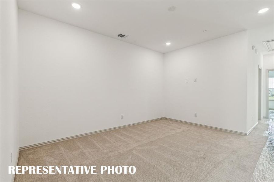 The upstairs game room offers an additional family living space or would make a perfect home office!  REPRESENTATIVE PHOTO