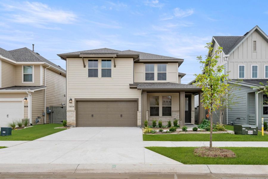 Front exterior of a new home in Cottage Collection at Harvest, Argyle, TX, highlighting curb appeal (Image 1).