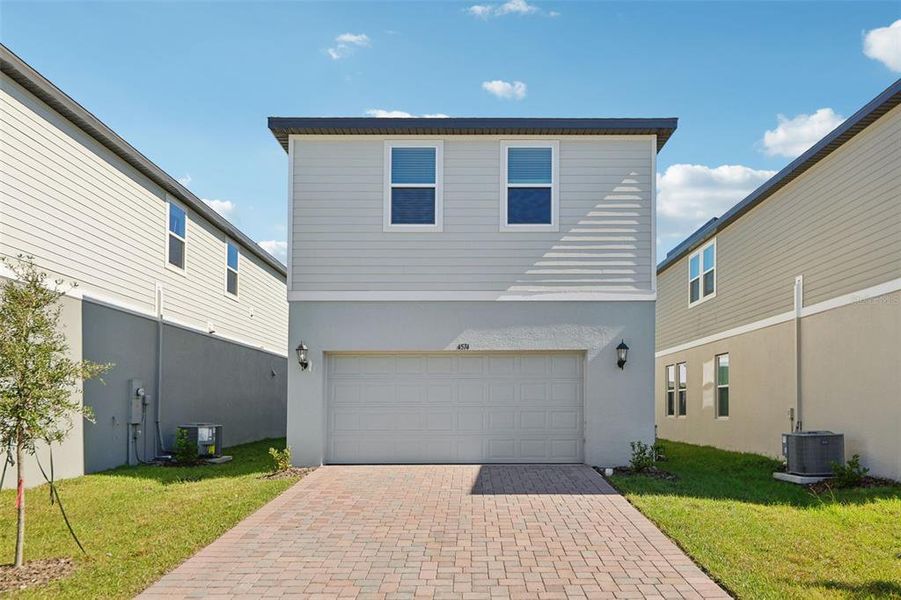 Front exterior of a new home in The Meadow at Crossprairie Bungalows, St. Cloud, FL, highlighting curb appeal (Image 26).