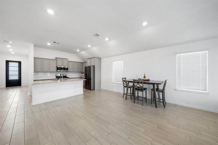 The home's open floor plan is perfect for entertaining, seamlessly connecting the living, dining, and kitchen areas to create an inviting and spacious atmosphere for gatherings.