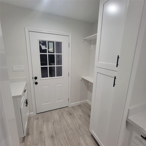 INSIDE UTILITY ROOM WITH PANTRY - MODEL HOME 114