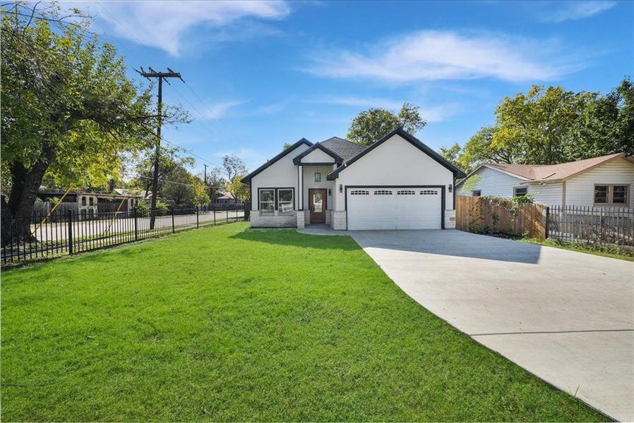 Ranch-style home featuring concrete driveway, stucco siding, an attached garage, and stone siding