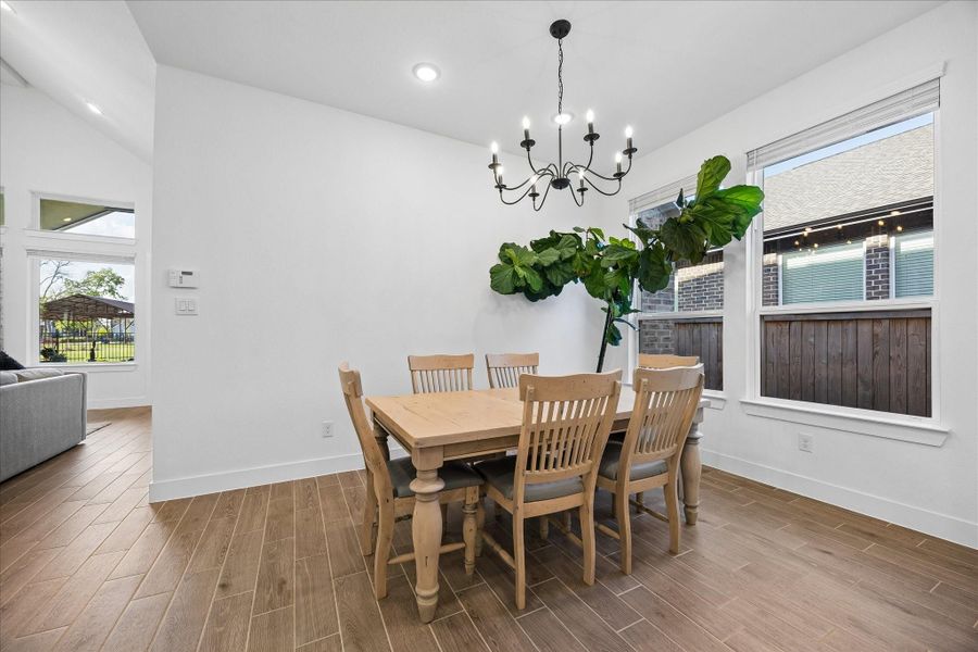 Dining area sits just off the main living space, anchored by a statement chandelier and surrounded by windows that bring in soft natural light. Open connection to the family room creates an easy flow for everyday living and entertaining. Dining area sits just off the main living space, anchored by a statement chandelier and surrounded by windows that bring in soft natural light. Open connection to the family room creates an easy flow for everyday living and entertaining.