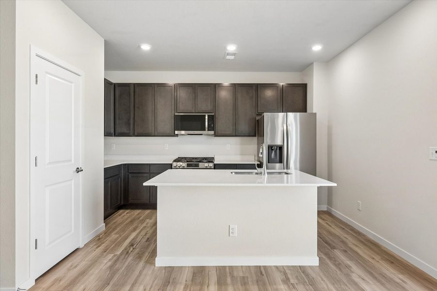 A kitchen with black cabinets.