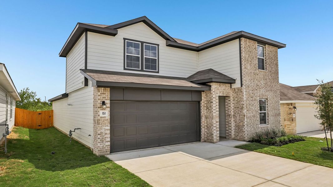 Front exterior of a new home in Prairie Lakes, Buda, TX, highlighting curb appeal (Image 18).
