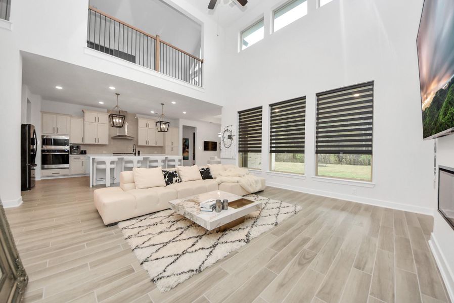 Modern open layout with high ceilings, large windows, and gourmet kitchen view.