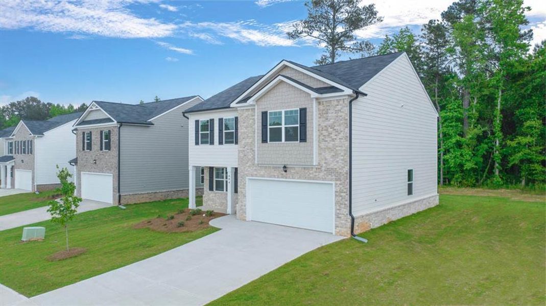 Front exterior of a new home in The Reserve at Calcutta, Stockbridge, GA, highlighting curb appeal (Image 17).