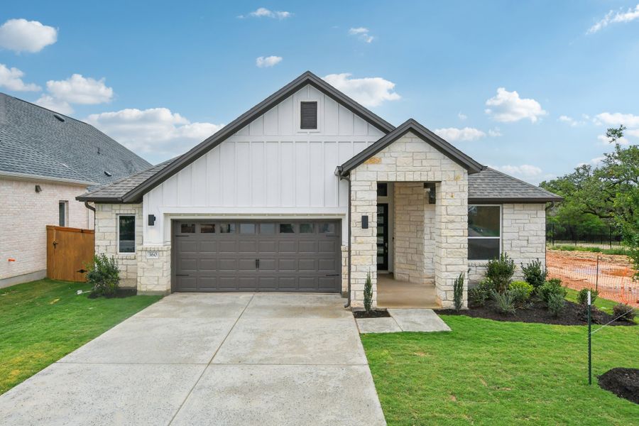 Front exterior of a new home in Persimmon, Buda, TX, highlighting curb appeal (Image 2). Front exterior of a new home in Persimmon, Buda, TX, highlighting curb appeal (Image 2).