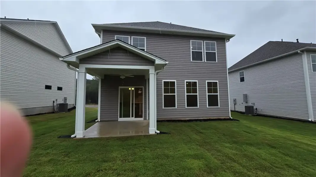 A spacious covered patio overlooks the manicured g