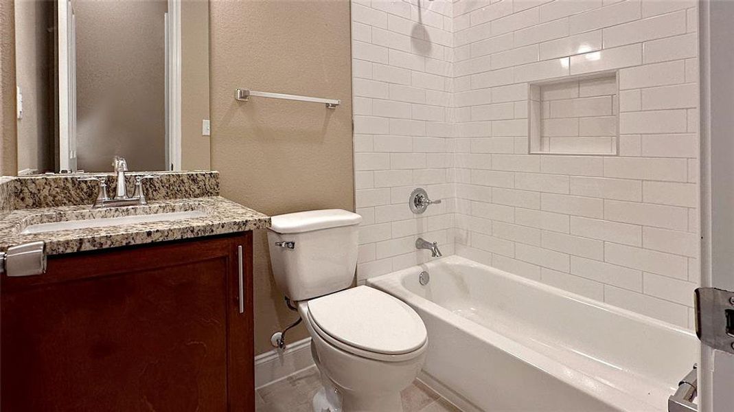 Tile to ceiling plus niche, granite vanity