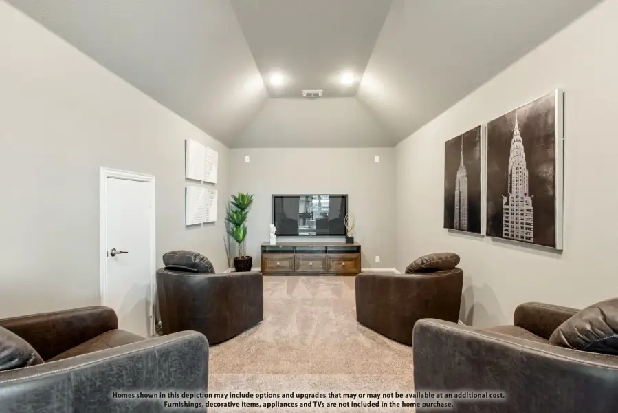 Living room with vaulted ceiling, carpet flooring, and leather chairs facing a TV console Living room with vaulted ceiling, carpet flooring, and leather chairs facing a TV console