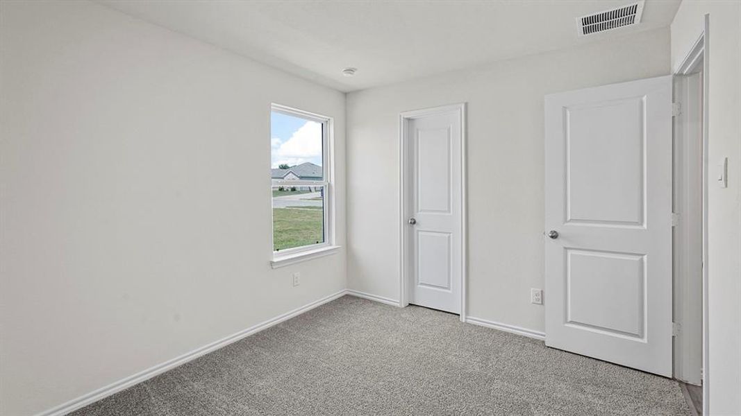 Carpeted interior room with white walls