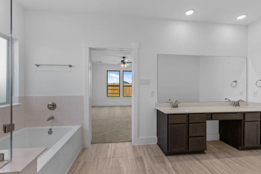 Soft, neutral tones and high-end finishes create a spa-like atmosphere from the moment you step inside this bathroom retreat.