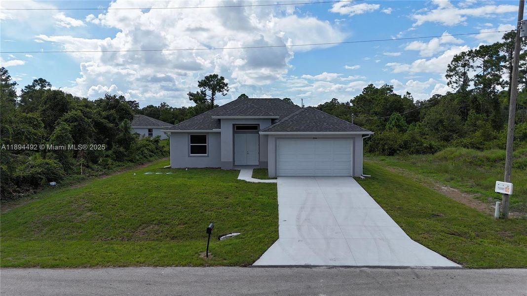Front exterior of a new home in , Lehigh Acres, FL, highlighting curb appeal (Image 22). Front exterior of a new home in , Lehigh Acres, FL, highlighting curb appeal (Image 22).