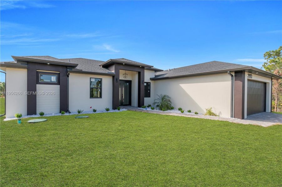 Front exterior of a new home in , Lehigh Acres, FL, highlighting curb appeal (Image 24).