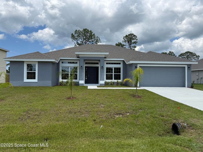 Front exterior of a new home in Palm Bay, Palm Bay, FL, highlighting curb appeal (Image 2). Front exterior of a new home in Palm Bay, Palm Bay, FL, highlighting curb appeal (Image 2).