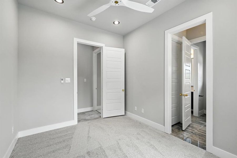 Unfurnished bedroom with light carpet, recessed lighting, a ceiling fan, and connected bathroom