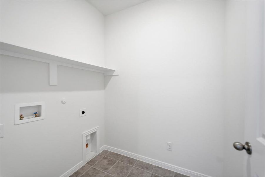 Room featuring light wood-finish flooring, white walls, and a single window with grids