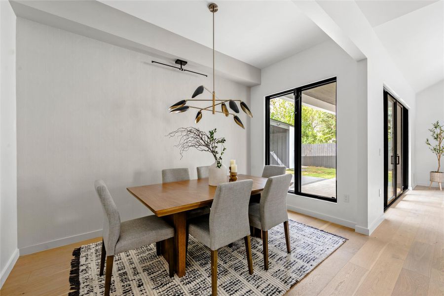 Dining room featuring light wood-style flooring and baseboards