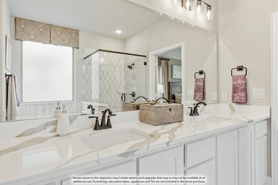 Master bathroom with double vanity, marble countertops, white cabinets, and glass-enclosed shower in background. Master bathroom with double vanity, marble countertops, white cabinets, and glass-enclosed shower in background.