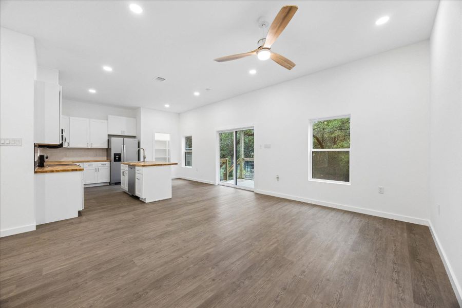 An open-concept living space integrates a modern kitchen and a naturally illuminated living area.