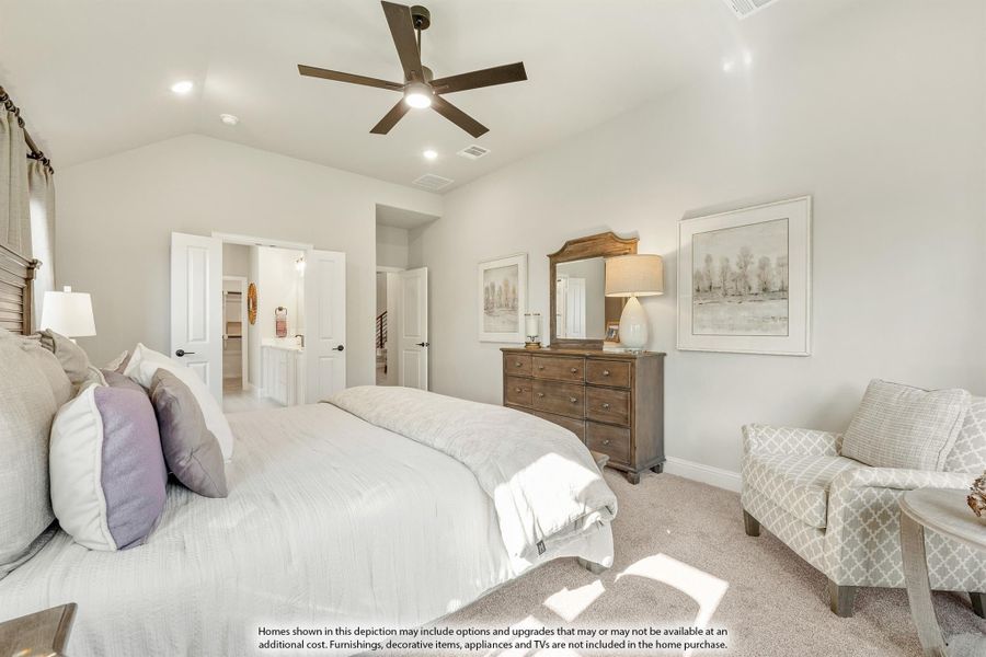 Master bedroom with vaulted ceiling, ceiling fan, carpet flooring, and ensuite bathroom access Master bedroom with vaulted ceiling, ceiling fan, carpet flooring, and ensuite bathroom access