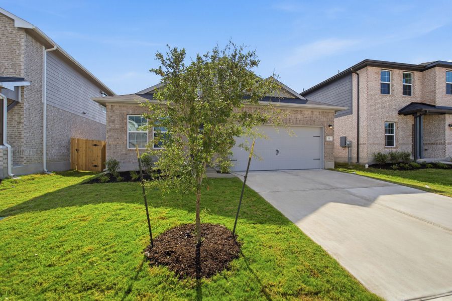 Front exterior of a new home in Sunfield, Buda, TX, highlighting curb appeal (Image 26). Front exterior of a new home in Sunfield, Buda, TX, highlighting curb appeal (Image 26).