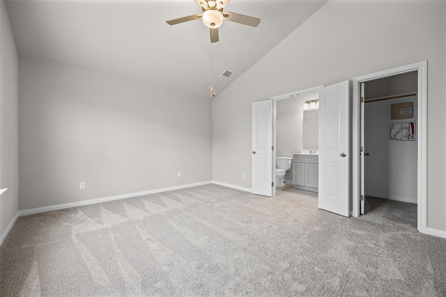 Vaulted ceilings soar over plush carpeting, leading directly into an en suite bathroom. Vaulted ceilings soar over plush carpeting, leading directly into an en suite bathroom.