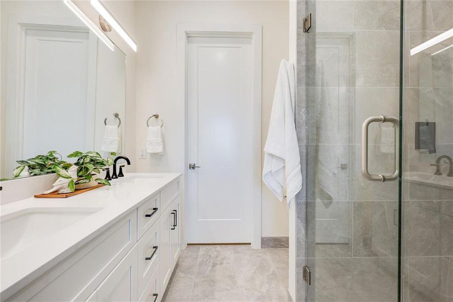 Bathroom featuring an enclosed shower and vanity