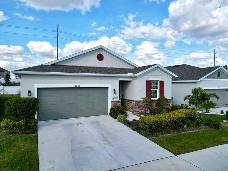 Front exterior of a new home in Seasons at Heritage Square, Haines City, FL, highlighting curb appeal (Image 2). Front exterior of a new home in Seasons at Heritage Square, Haines City, FL, highlighting curb appeal (Image 2).
