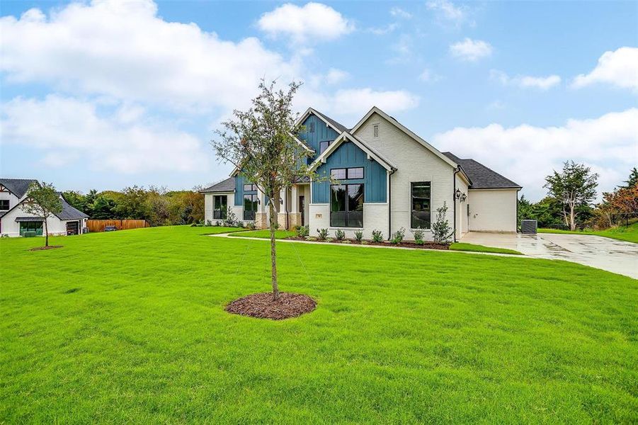 Craftsman inspired home with cooling unit and a front yard